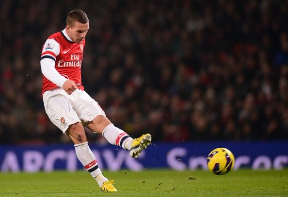 Lukas Podolski of Arsenal scores their first goal during the Barclays Premier League match between Arsenal and West Ham United at Emirates Stadium on January 23, 2013 in London, England. (Photo by Mike Hewitt/Getty Images)